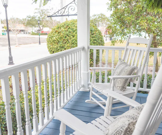 Two front porch rocking chairs overlooking the main street and yard.
